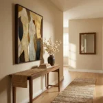 Layered abstract hand-painted canvas in earthy golds, creams, and charcoal tones, contemporary entryway
