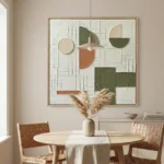 Abstract hand-painted canvas with geometric shapes in sage green, terracotta, and cream tones, contemporary dining space