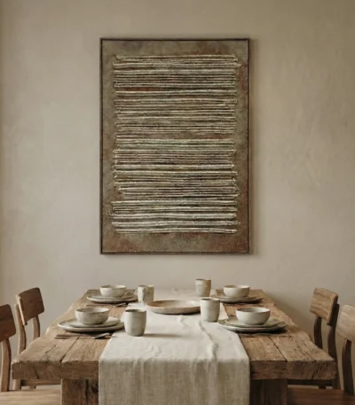Textured abstract hand-painted canvas with horizontal linear relief marks in warm metallic gold and cream tones, contemporary dining space