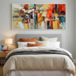 Gestural abstract expressionist hand-painted canvas in vibrant reds, oranges, yellows and blues with dynamic brushstrokes, modern bedroom