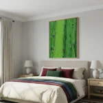 Textured impressionist hand-painted canvas depicting vibrant green hillside with scattered red figures and gestural brushwork, modern bedroom setting