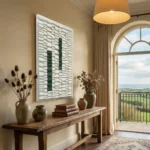 Minimalist hand-painted canvas with geometric green brushstrokes on white textured background, coastal interior setting