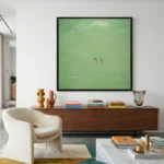 Minimalist hand-painted canvas depicting two figures in emerald water, serene coastal landscape painting, contemporary living space