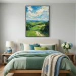 Impressionist landscape hand-painted canvas depicting rolling green hills, distant ocean, and dramatic sky in blue and cream tones, modern bedroom