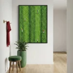 Figurative hand-painted canvas depicting scattered figures across vibrant lime-green textured field, contemporary entryway