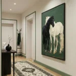Figurative hand-painted canvas depicting two horses in cream and black against deep green, hallway setting