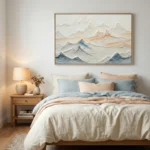 Textured landscape hand-painted canvas depicting layered mountains in soft grays, blues, and warm earth tones, modern bedroom