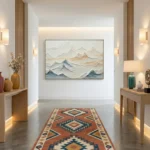 Textured landscape hand-painted canvas depicting layered mountains in soft grays, blues, and warm earth tones, contemporary gallery space