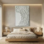 Textured abstract hand-painted canvas in monochromatic white and grey with layered gestural brushwork, contemporary bedroom
