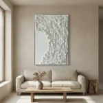 Textured abstract hand-painted canvas in layered white and cream tones with gestural brushwork, contemporary living space