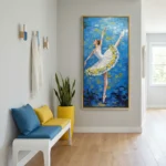 Figurative hand-painted canvas of a ballet dancer in white tutu with yellow petal details against layered blue and gold background, contemporary entryway