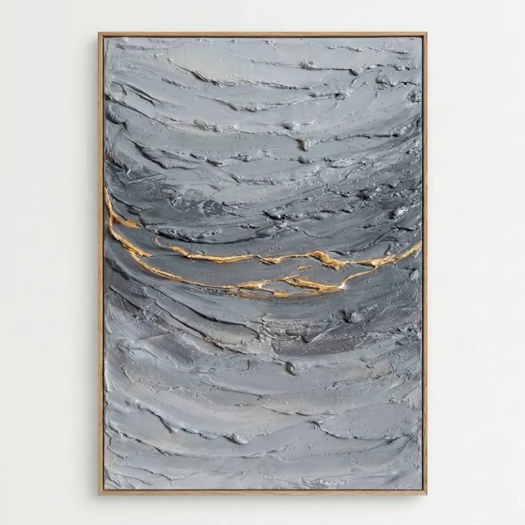 Textured abstract hand-painted canvas in layered grey tones with golden gestural brushstrokes, contemporary living space