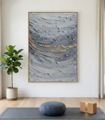 Textured abstract hand-painted canvas in layered grays with gold leaf accents, contemporary living space