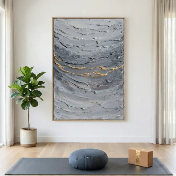 Textured abstract hand-painted canvas in layered grays with gold leaf accents, contemporary living space