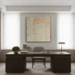 Textured abstract hand-painted canvas in cream and ochre with gestural brushwork, contemporary office setting