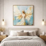 Textured figurative hand-painted canvas depicting an angelic figure with layered cream and gold wings against soft blue tones, modern bedroom