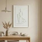 Minimalist hand-painted canvas depicting an abstract seated figure in soft gestural lines, neutral cream and beige palette, contemporary dining space