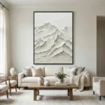Textured minimalist hand-painted canvas depicting layered snow-capped mountains in monochromatic cream and white tones, contemporary living space