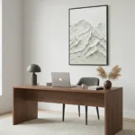 Textured minimalist hand-painted canvas depicting layered snow-capped mountains in monochromatic white and grey tones, contemporary office space