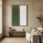 Minimalist hand-painted canvas with divided composition in muted sage green and cream, contemporary living space