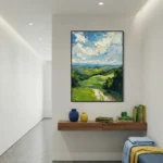 Impressionist landscape hand-painted canvas depicting rolling green hills, blue sky with cream clouds, and winding path in natural tones, contemporary hallway