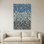 Textured abstract hand-painted canvas in layered blues, grays, and cream with dimensional relief, contemporary living space