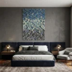 Textured abstract hand-painted canvas in layered blues, creams, and grays with dimensional brushwork, modern bedroom setting