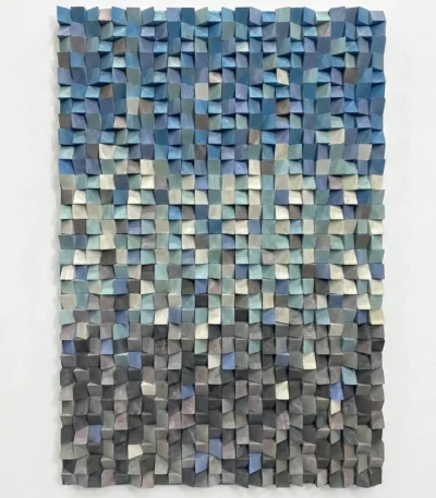 Textured abstract hand-painted canvas with layered dimensional squares in cool blues, greens, and neutral tones, contemporary living space