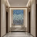 Textured abstract hand-painted canvas in gradient blue, cream, and charcoal pixelated squares, contemporary entryway
