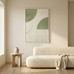 Minimalist abstract hand-painted canvas with curved organic forms in sage green and cream tones, contemporary living space