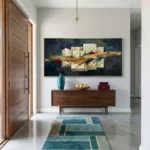 Contemporary abstract hand-painted canvas with golden driftwood and cream geometric forms on deep navy, modern entryway