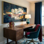 Layered abstract hand-painted canvas with gestural brushstrokes in deep teals, golds, and burgundy tones, contemporary office setting