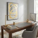 Gestural abstract hand-painted canvas with bold gold brushstrokes on neutral grey ground, contemporary home office