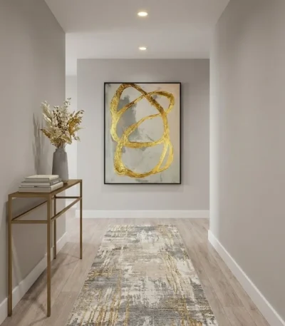 Gestural abstract hand-painted canvas with looping gold brushstrokes on cream and grey, contemporary hallway setting