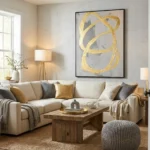 Gestural abstract hand-painted canvas with gold leaf swirling loops on grey and cream, contemporary living space