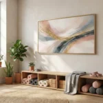 Gestural abstract hand-painted canvas with flowing gold, blush, and charcoal strokes in soft, layered tones, contemporary living space