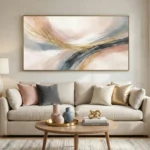 Layered abstract hand-painted canvas with sweeping gestural brushstrokes in gold, charcoal, and blush tones, contemporary living space