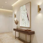 Textured abstract hand-painted canvas in cream, white, and burgundy with gold leaf accents, modern entryway