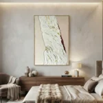 Textured abstract hand-painted canvas with white impasto and burgundy accent, cream and gold tones, contemporary bedroom
