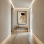 Contemporary figurative hand-painted canvas depicting woman in flowing white gown with dark flowing hair, warm cream and gold palette, modern hallway