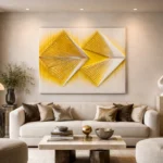 Contemporary abstract hand-painted canvas featuring geometric arrow forms in vibrant yellow and cream tones, modern living space