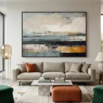 Layered abstract hand-painted canvas in cream, charcoal, and ochre horizontal strokes, contemporary living space