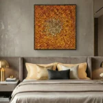 Textured abstract hand-painted canvas in warm golden and amber tones with layered circular motifs, modern bedroom setting