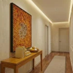 Textured abstract hand-painted canvas in warm golden orange and red tones, contemporary entryway