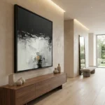 Gestural abstract expressionist hand-painted canvas in monochromatic black, white and ochre with dynamic brushwork, contemporary hallway