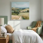 Impressionist landscape painting depicting rolling hills with wheat fields and distant mountains in soft greens and golds, styled in a contemporary bedroom