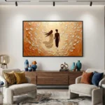 Textured abstract hand-painted canvas depicting two silhouetted figures in warm ochre and cream tones, contemporary living space