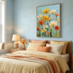 Impressionist hand-painted canvas of vibrant gerbera daisies in yellow, orange and cream against soft blue, contemporary bedroom