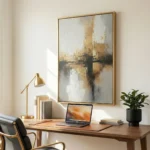 Abstract impressionist hand-painted canvas depicting layered cityscape in warm golds and cool grays, modern workspace