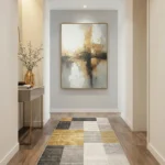 Layered abstract landscape hand-painted canvas in warm golds, soft greys and creams with reflective water tones, contemporary entryway